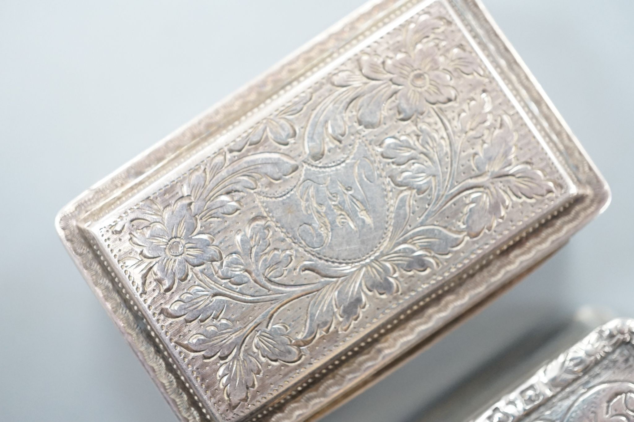 A George IV engraved silver rectangular vinaigrette, by Nathaniel Mills, Birmingham, 1827, engraved 'Celia', 31mm and a later vinaigrette, Birmingham, 1833.